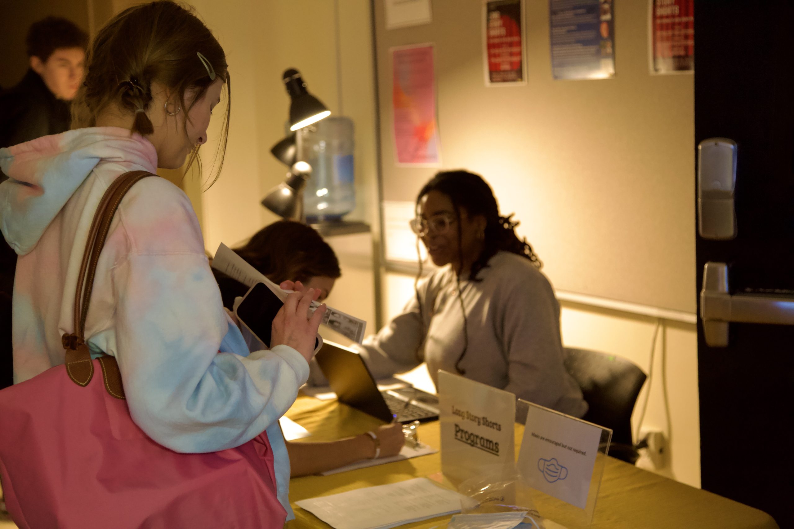 Students at the check-in table for Long Story Shorts